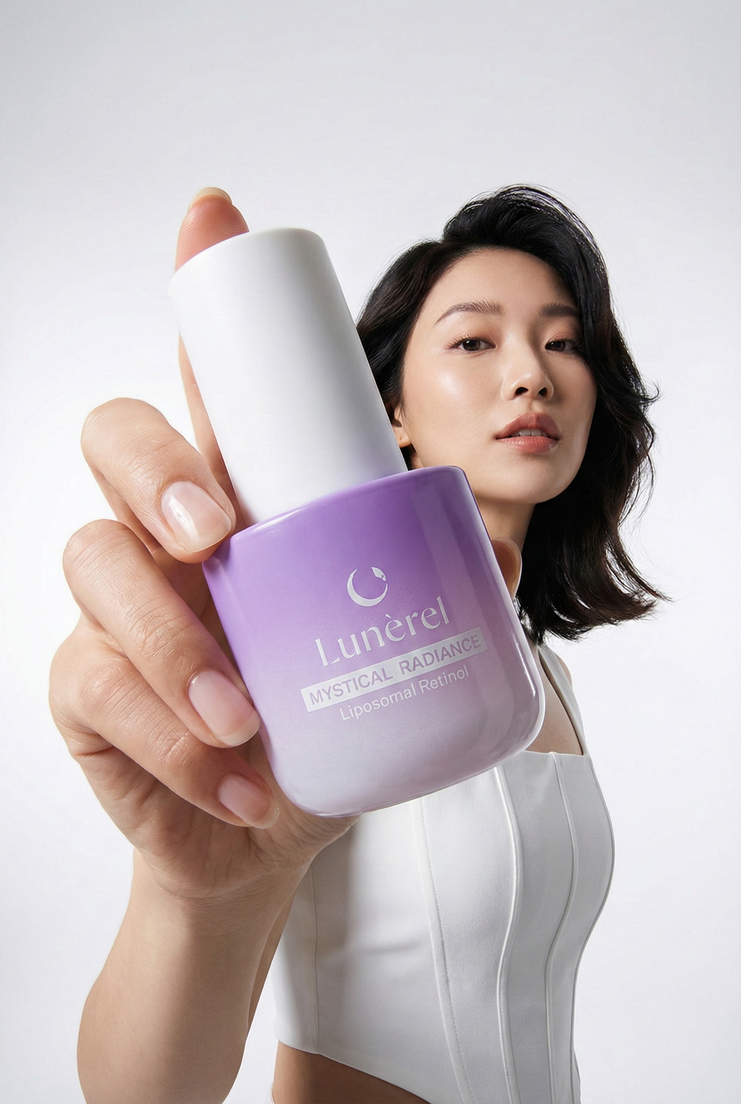 Model holding Lunérel Mystical Radiance Serum with liposomal retinol