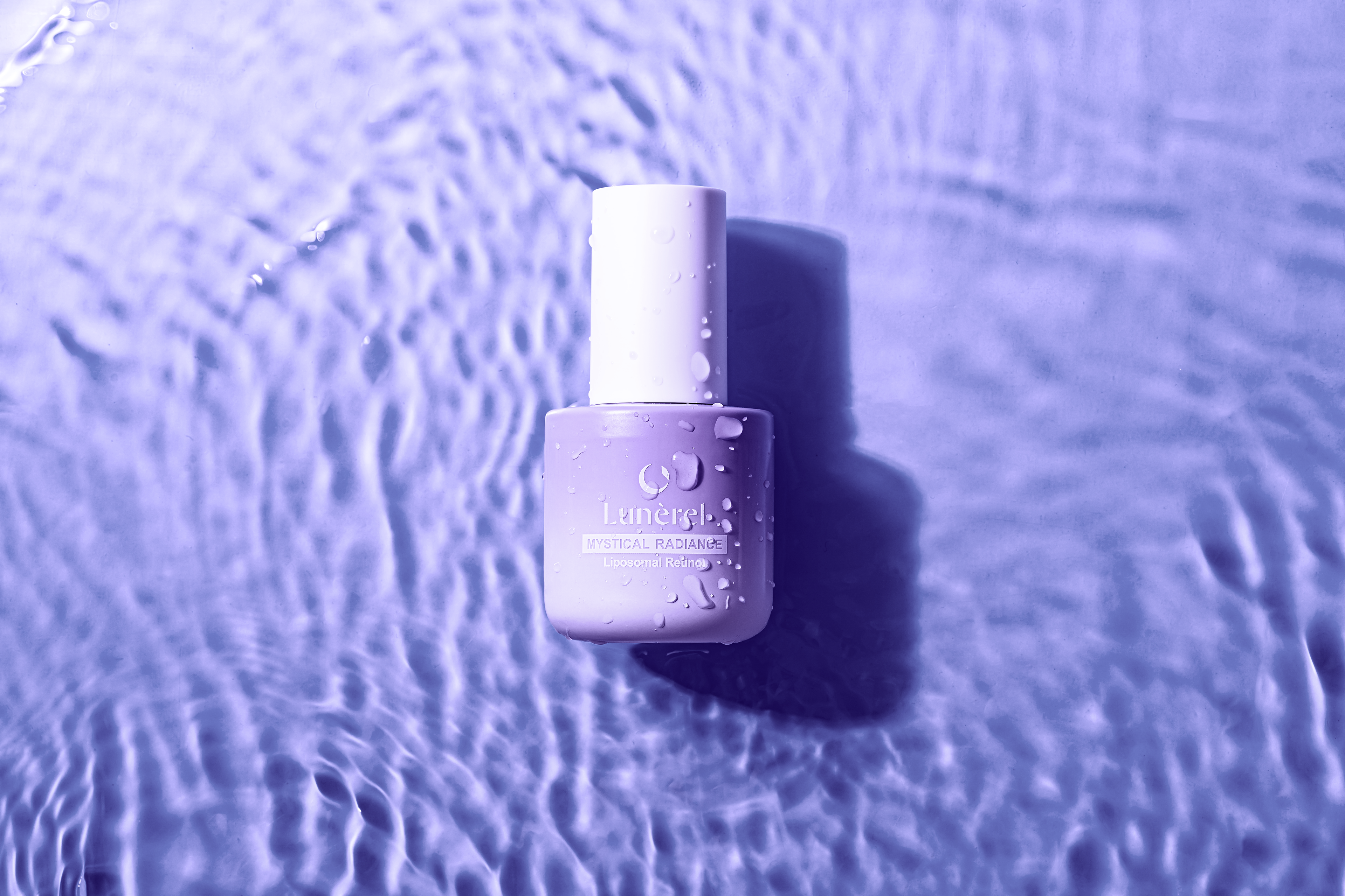 Lunérel Mystical Radiance Serum with liposomal retinol in water-inspired setting